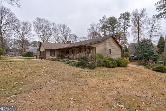 view of side of property with a yard