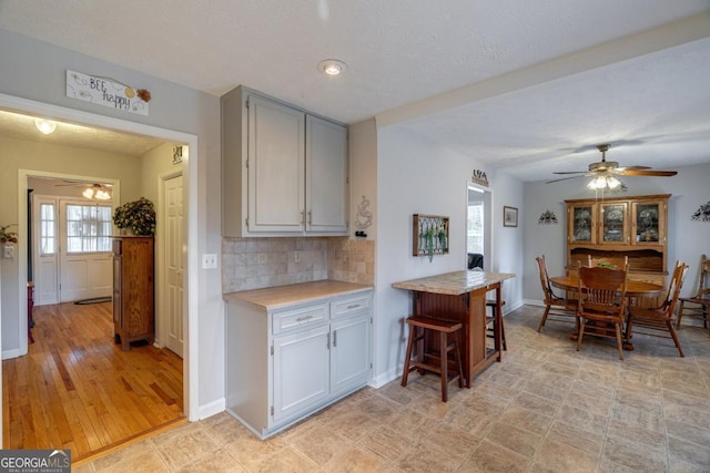 kitchen with decorative backsplash and ceiling fan