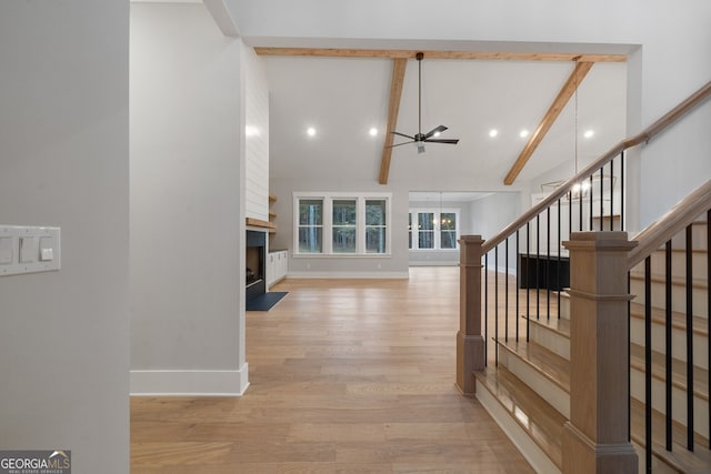 interior space featuring vaulted ceiling with beams and light wood-type flooring