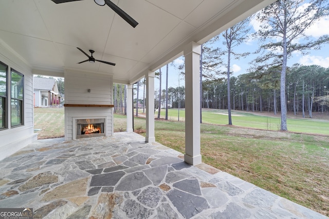 view of patio with a tile fireplace and ceiling fan