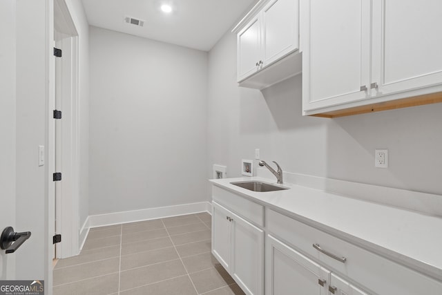 laundry area with sink, hookup for a washing machine, cabinets, and light tile patterned flooring