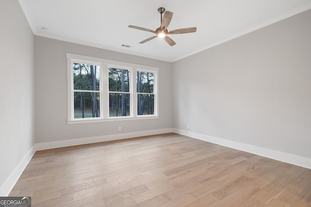 spare room featuring ceiling fan, ornamental molding, and light hardwood / wood-style flooring