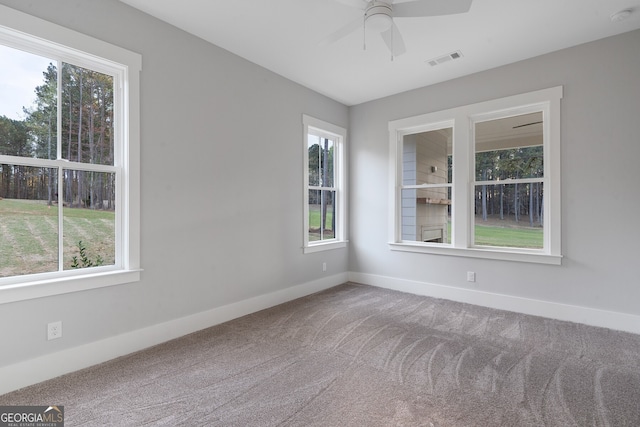 carpeted spare room with ceiling fan