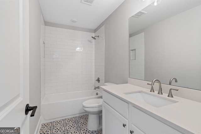 full bathroom with tile patterned floors, toilet, tiled shower / bath combo, and vanity