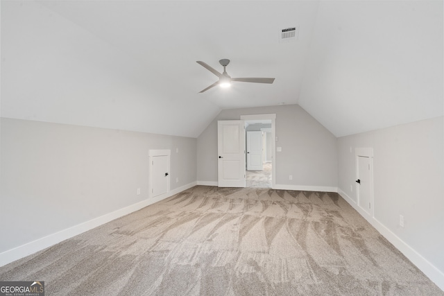 bonus room featuring ceiling fan, lofted ceiling, and light colored carpet