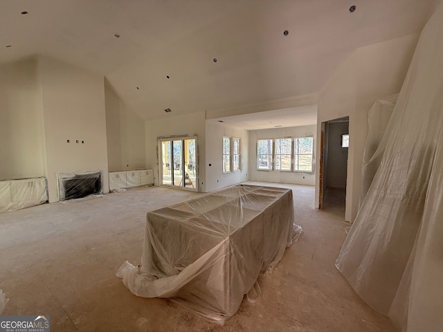 living room featuring high vaulted ceiling