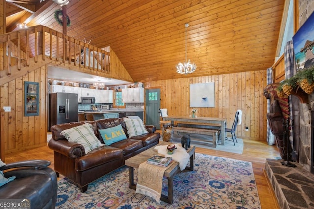 living room with an inviting chandelier, wood ceiling, and high vaulted ceiling