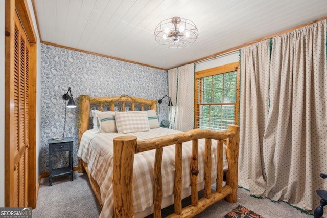 carpeted bedroom featuring crown molding and a closet