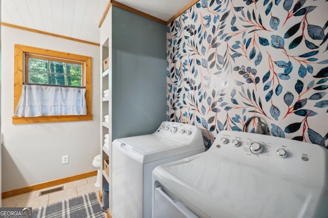 clothes washing area featuring crown molding, wood ceiling, tile patterned floors, and washer and dryer