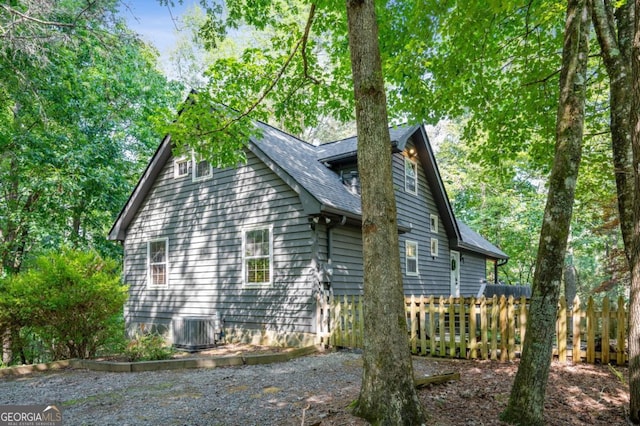 view of side of property featuring central air condition unit