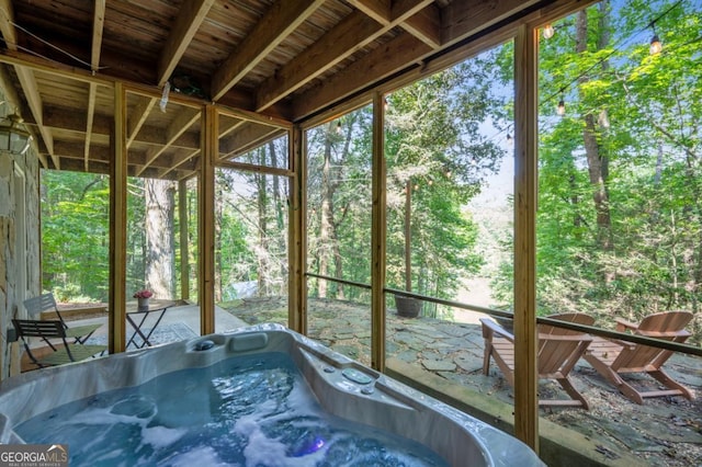 unfurnished sunroom featuring a jacuzzi