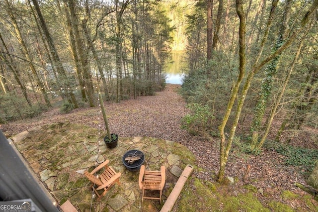 view of yard with a fire pit and a patio