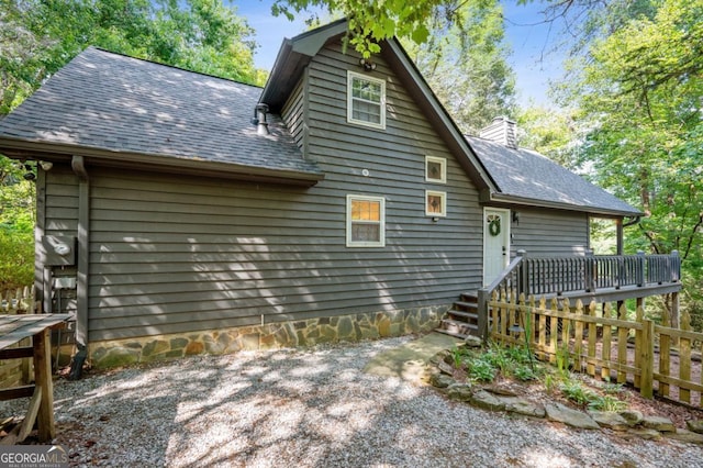 back of house with a wooden deck