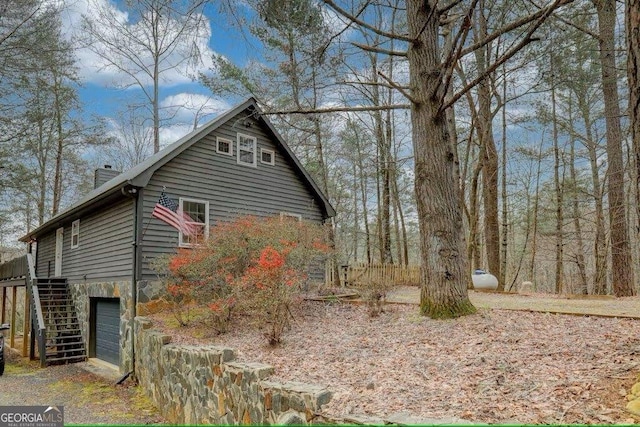 view of side of home featuring a garage