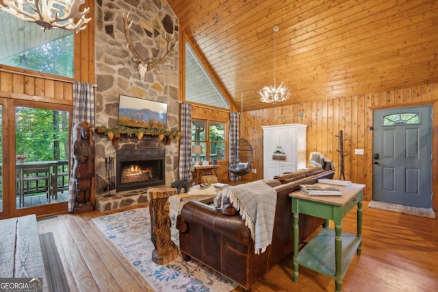 living room with a healthy amount of sunlight, a chandelier, and high vaulted ceiling