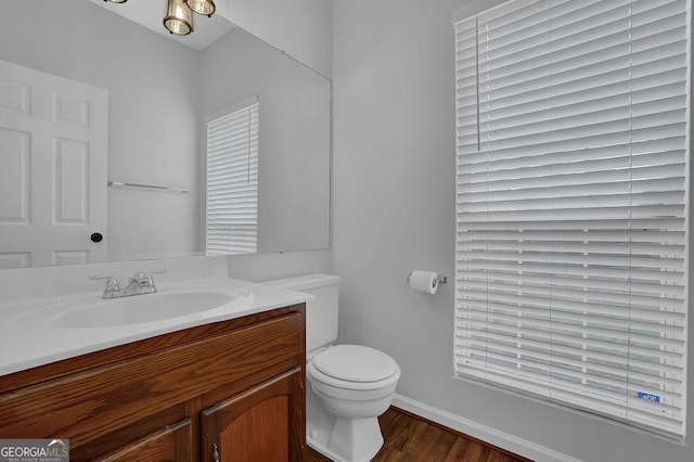 bathroom with vanity, hardwood / wood-style flooring, and toilet