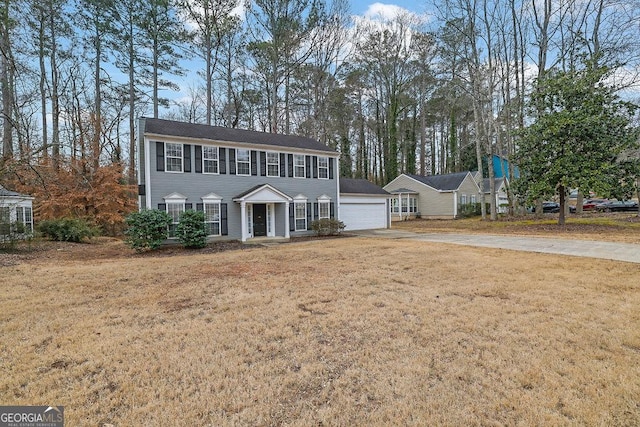 colonial house with a garage and a front yard