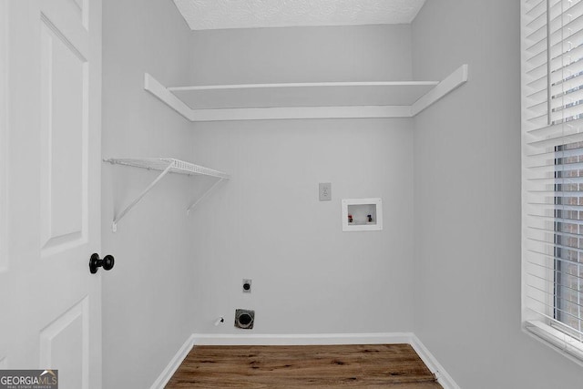 laundry room featuring washer hookup, hardwood / wood-style floors, hookup for an electric dryer, and a textured ceiling