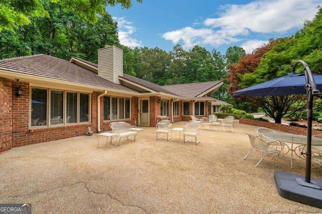 back of house with a patio