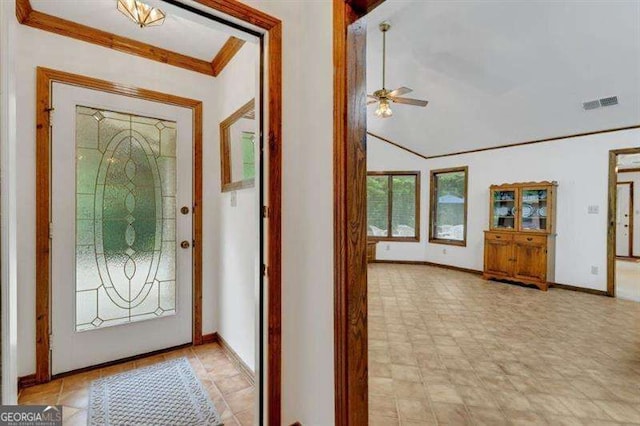 foyer entrance with crown molding and ceiling fan