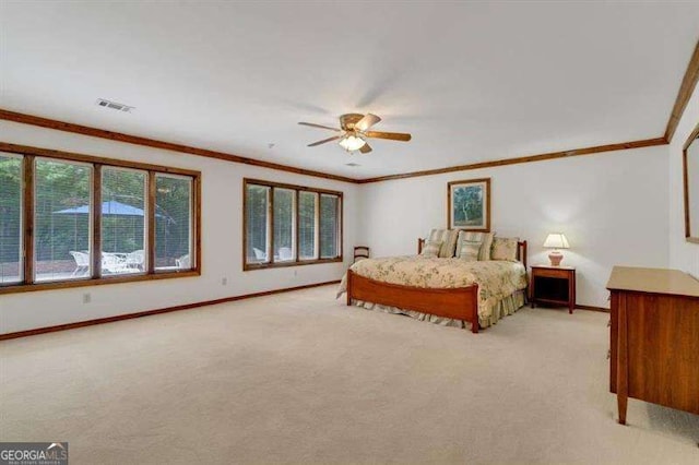 bedroom with ceiling fan, ornamental molding, and light colored carpet