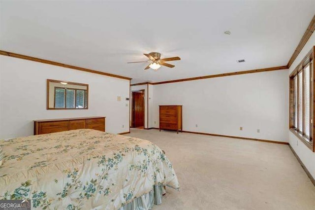 bedroom featuring ornamental molding, light colored carpet, and ceiling fan