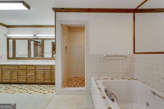 bathroom with tile walls, vanity, tile patterned flooring, and separate shower and tub