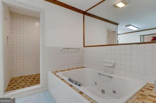 bathroom featuring independent shower and bath