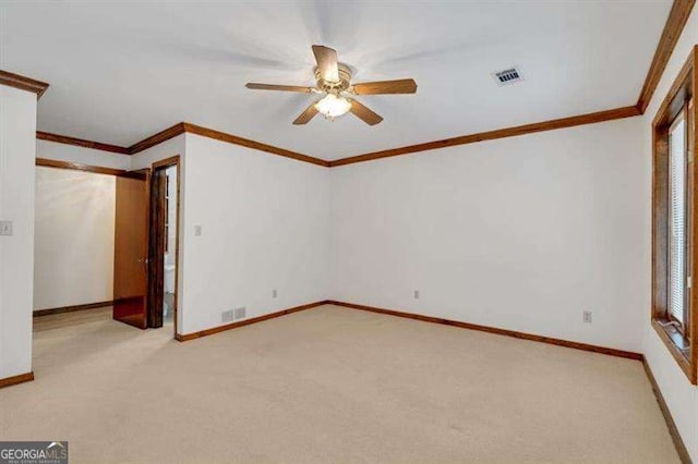 unfurnished bedroom with light carpet, ornamental molding, and ceiling fan