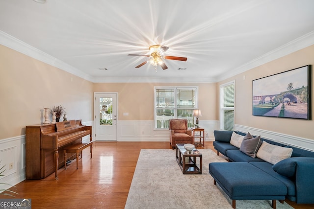 living room with ornamental molding and light hardwood / wood-style floors