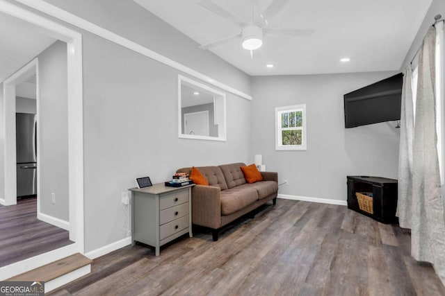 living room with hardwood / wood-style flooring, lofted ceiling, and ceiling fan