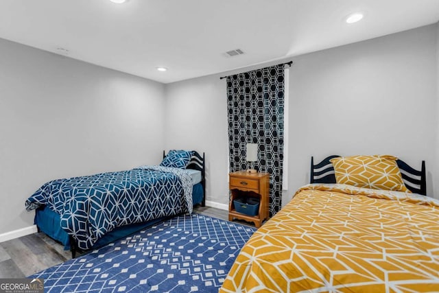 bedroom with dark hardwood / wood-style flooring