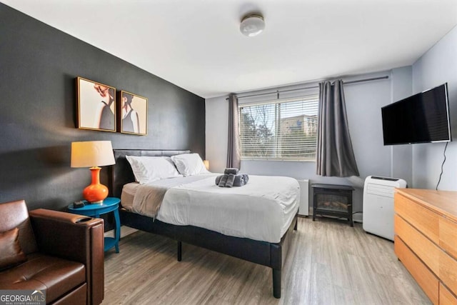 bedroom with light wood-type flooring