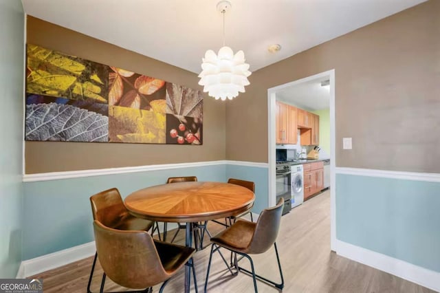 dining room with an inviting chandelier and light wood-type flooring