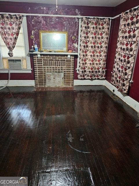 unfurnished living room with cooling unit and wood-type flooring