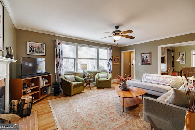 living room with crown molding, ceiling fan, and light hardwood / wood-style floors