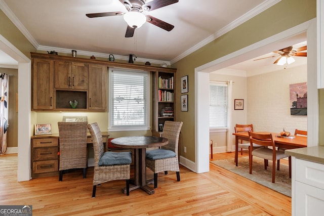 dining area with crown molding, light hardwood / wood-style floors, and ceiling fan