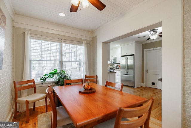 dining space featuring wood ceiling, light hardwood / wood-style flooring, ornamental molding, and ceiling fan