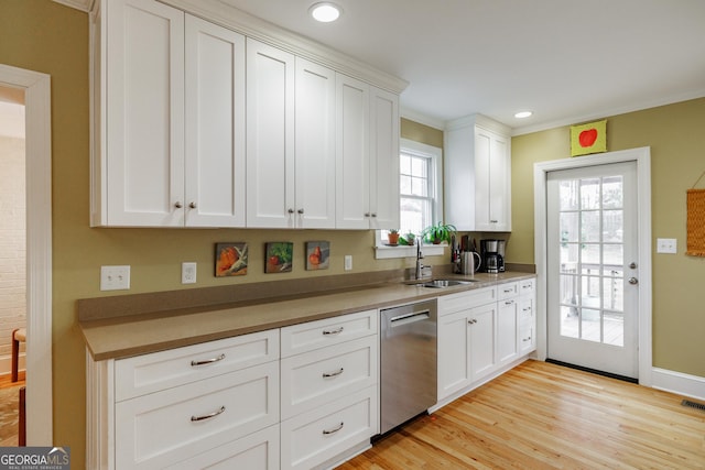 kitchen with sink, plenty of natural light, white cabinets, and dishwasher