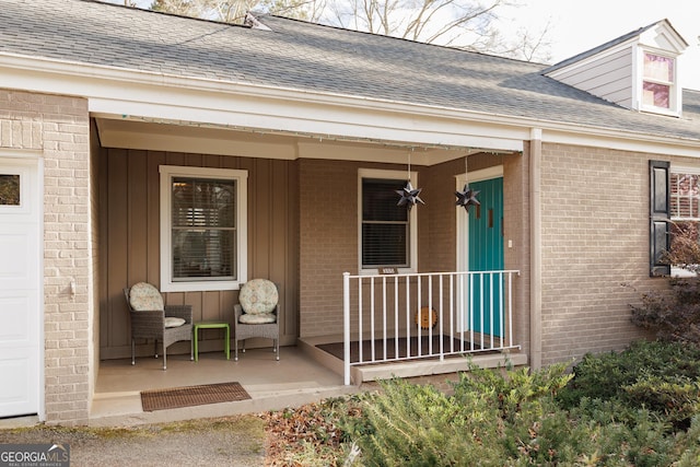 view of exterior entry with a porch