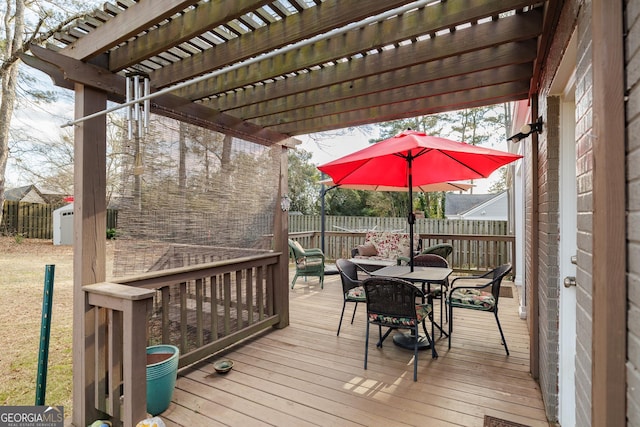 wooden deck with a storage shed and a pergola