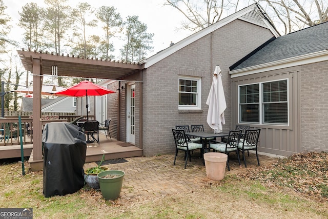 view of patio / terrace featuring a wooden deck, grilling area, and a pergola