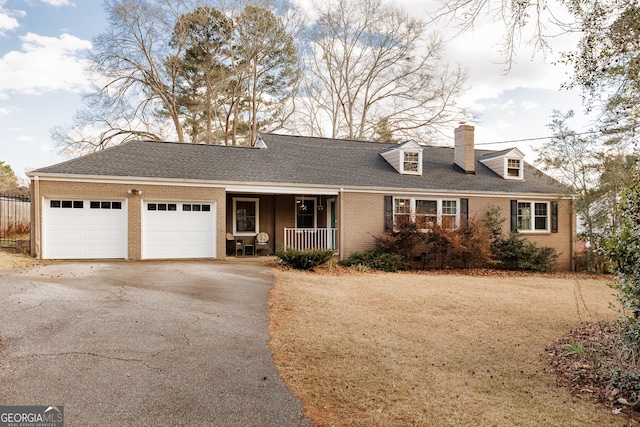 view of front of home with a porch and a garage