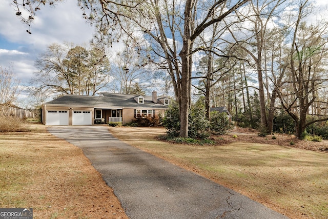 view of front of home with a garage and a front lawn