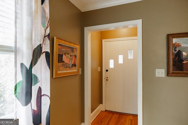 doorway to outside with ornamental molding and light hardwood / wood-style flooring