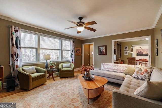 living room with crown molding, ceiling fan, and light hardwood / wood-style flooring