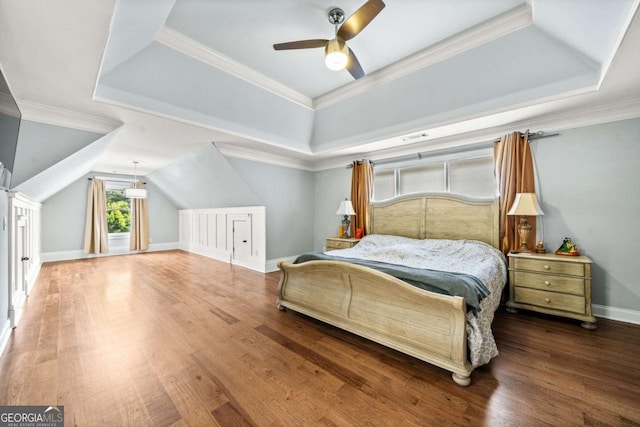 bedroom featuring crown molding, hardwood / wood-style floors, ceiling fan, and a tray ceiling