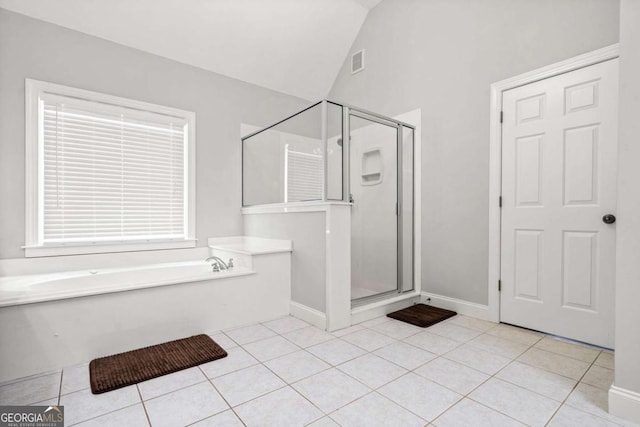 bathroom with independent shower and bath, lofted ceiling, and tile patterned flooring