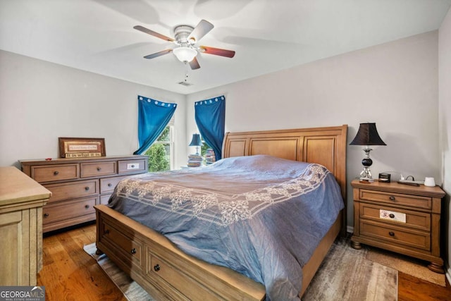 bedroom featuring hardwood / wood-style floors and ceiling fan