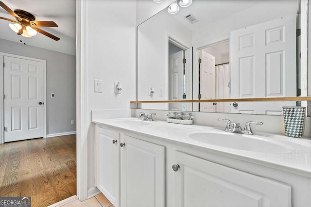 bathroom featuring hardwood / wood-style flooring, ceiling fan, and vanity